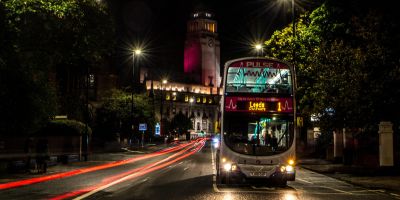 Image of a bus in Leeds city centre at night.