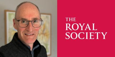 A portrait of Ken Carslaw, smiling, next to the logo of the Royal Society. The logo is red background with white text that says the Royal Society in capitals, serif font.