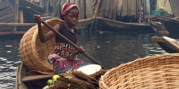Girl with baskets in boat