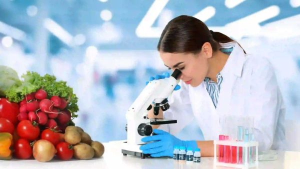 woman looking into microscope