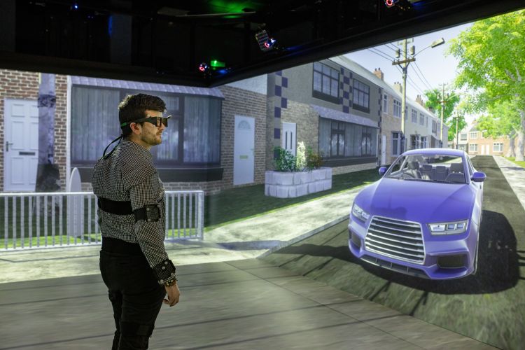a person stands in a virtual reality pd wearing virtual reality equipment