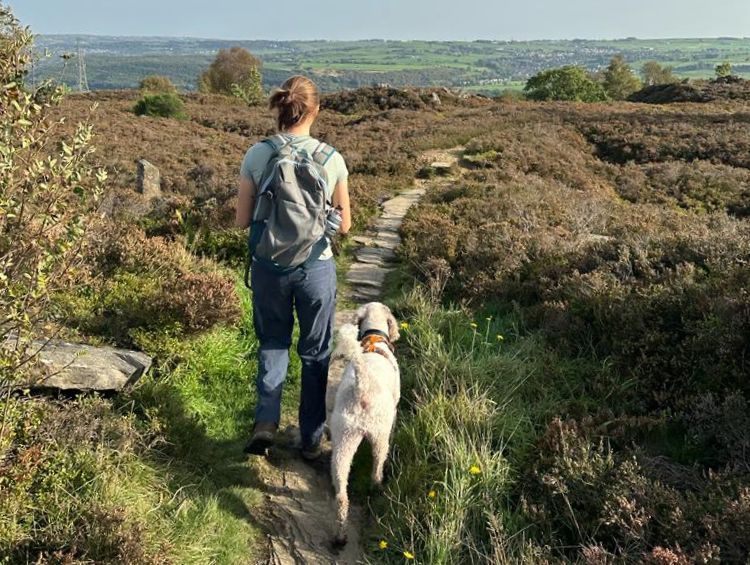 Image of Geography Masters student Jessica Arkesden walking her dog in the Yorkshire Moors
