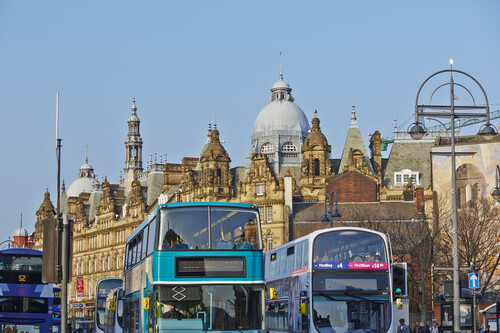 Buses in Leeds, with Kirkgate Markets in the background.