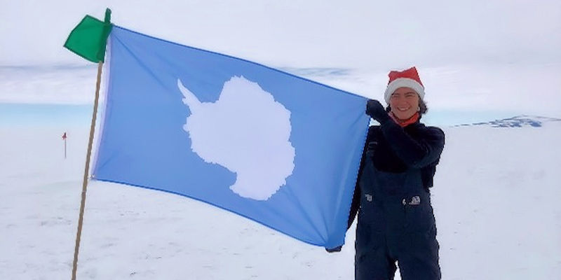 Bryony Freer with a flag at Ross Ice Shelf