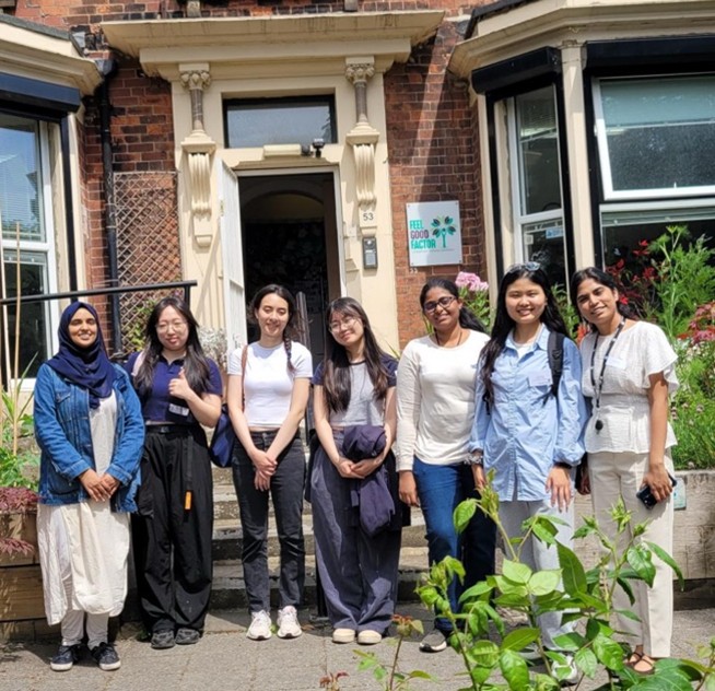 Members of the community stand outside a building