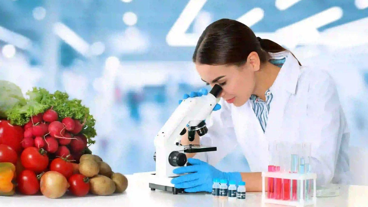 woman looking into microscope