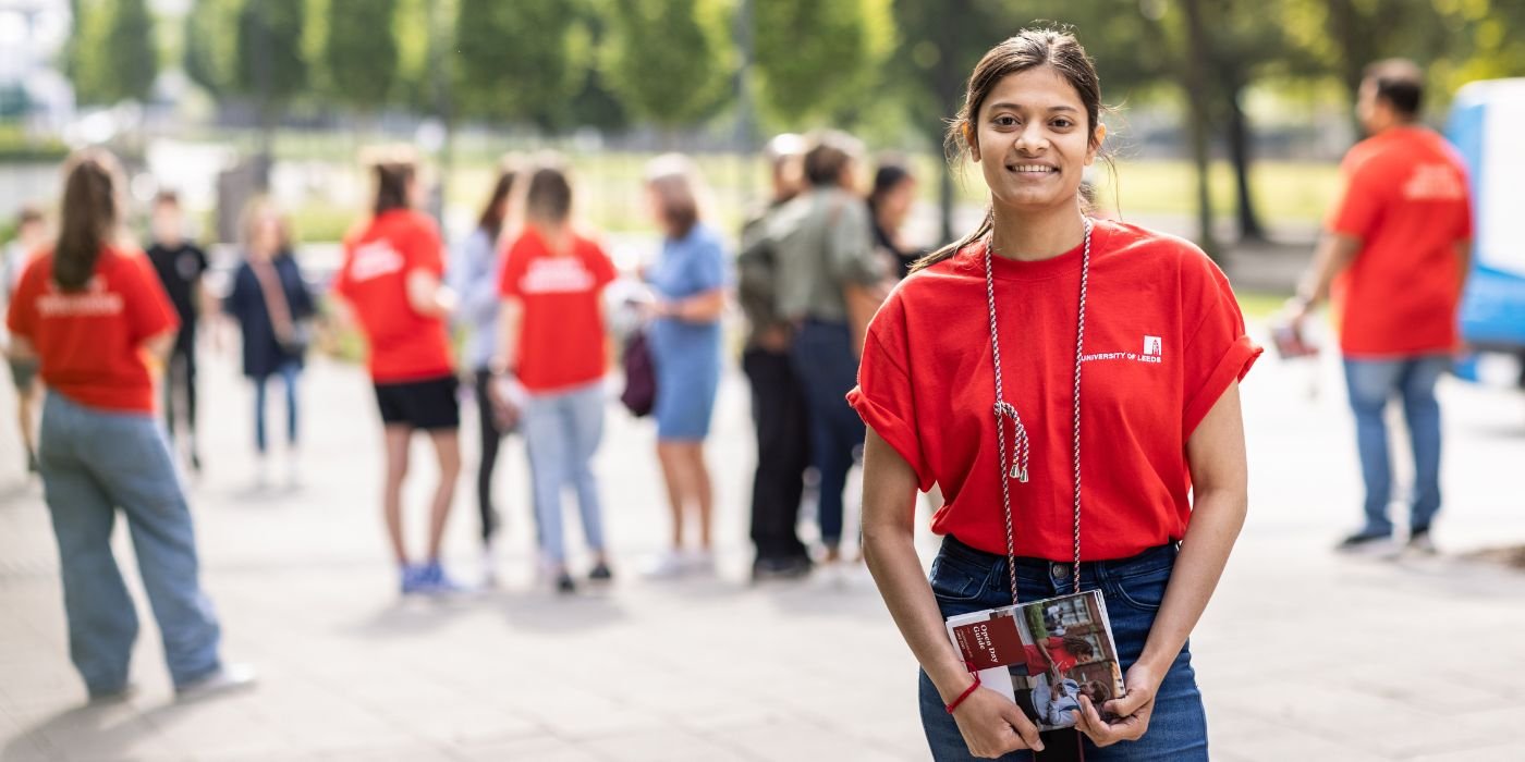 Image of students in their red ambassador t-shirts at the University of Leeds open day.