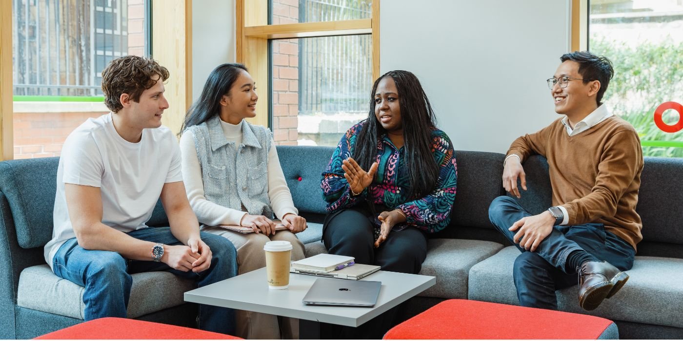 Image of students sat chatting in the foyer of the Institute for Transport Studies.