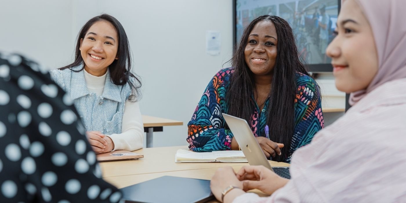 Image of ITS students in a seminar listening to someone speaking