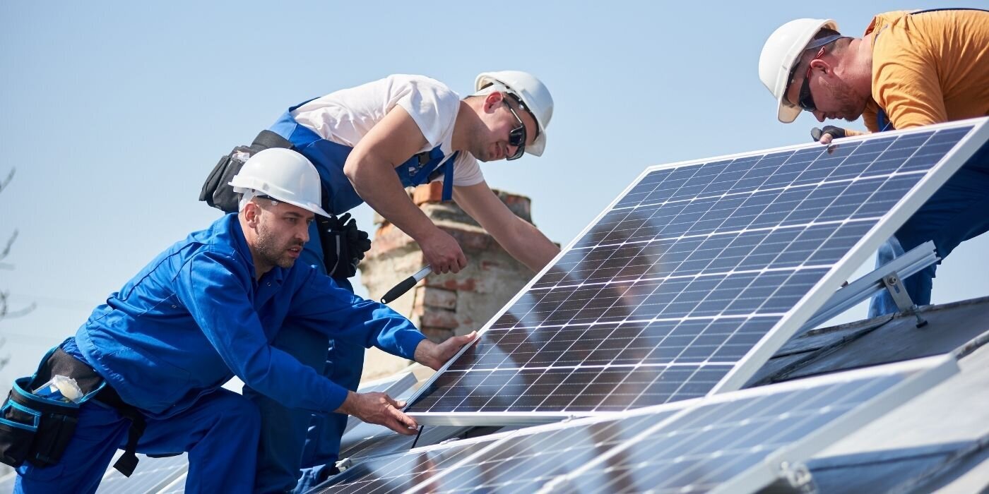 Engineers installing solar panels