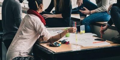 A group of students of different genders and ethnicities sit together studying