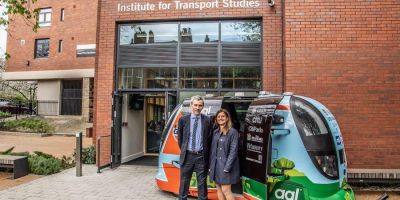 Professor Natasha Merat standing beside the driverless POD at Institute for Transport Studies University of Leeds.