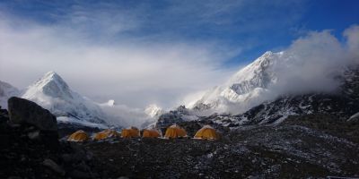 A photograph of six yellow tents set up on Mount Everest.