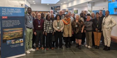 A large group of researchers including delegates from southern and eastern Africa, standing together in the Global Food and Environment Institute at Leeds.