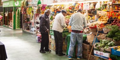 Three men at Kirkgate market standing over 