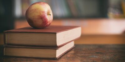 A red apple on two stacked books