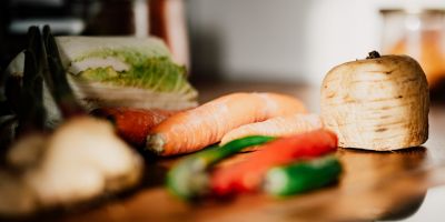 Vegetables (turnip, carrot, chilis) on a kitchen counter