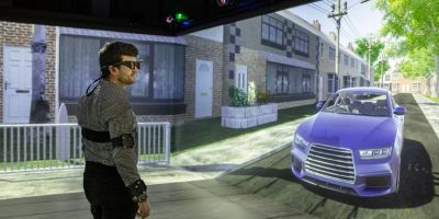 A man standing inside a virtual transport simulator