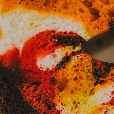 Photo of a multi coloured bagel slice