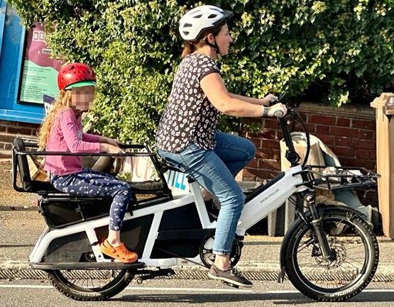 woman and child on bike side view