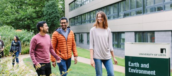 Postgraduate students walking school of Earth and Environment Leeds