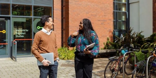 Image of two students chatting outside of the Institute for Transport Studies.