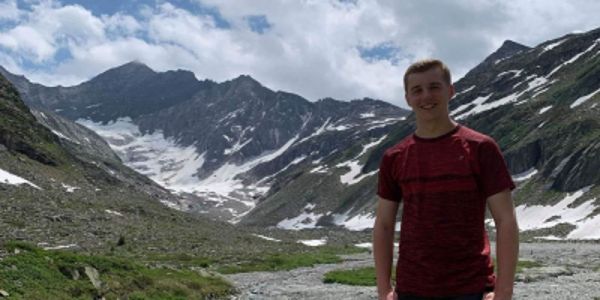 Ryan Pigott - Undergraduate Geography student stood by the mountains on a field trip