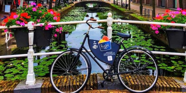 Image of a bike beside Amsterdam canal