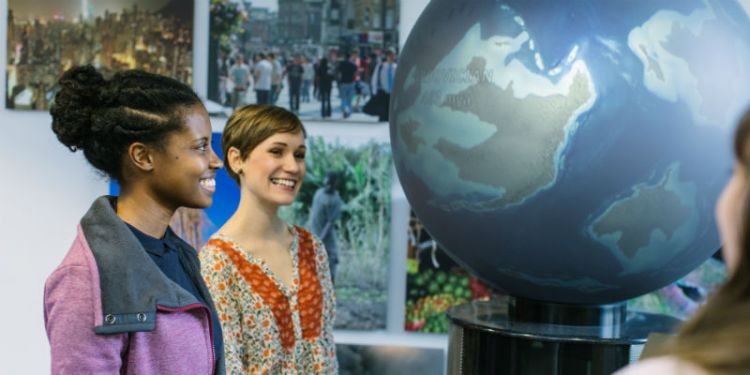 Two University of Leeds students with an interactive globe