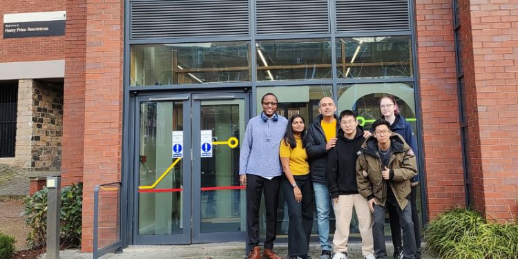 Image of ITS Masters student Mostafa Kazemi stood by the University of Leeds Institute of Transport building with his fellow students