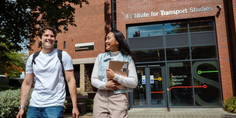 Image of two students walking outside the Institute for Transport Studies.