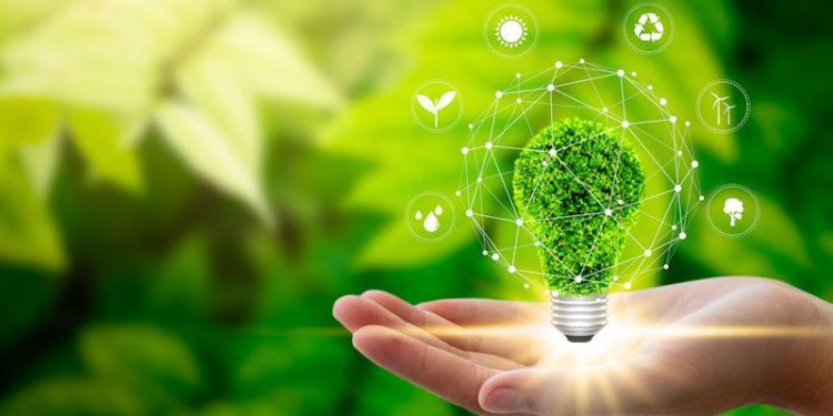 Abstract image with a hand holding light bulb against nature on green leaf with icons energy sources for renewable, sustainable development