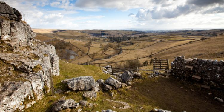 A rocky outcrop above a Yorkshire valley with farmed fields