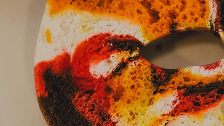 Photo of a multi coloured bagel slice
