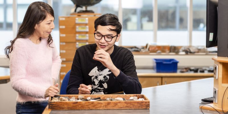 Student in earth sciences being taught about rocks