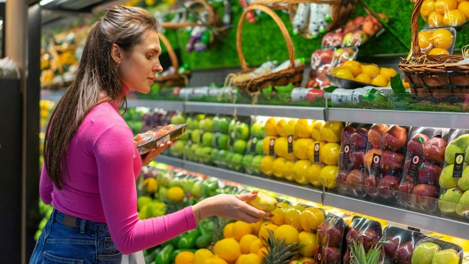 Woman  choosing fruit in a supermarket