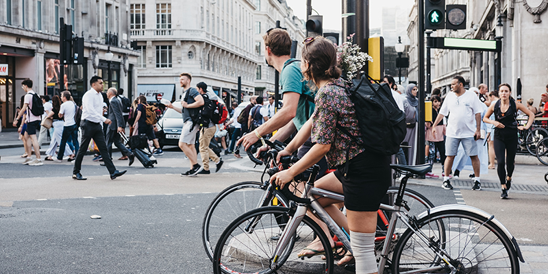 yclists waiting for traffic lights on Oxford Street near entrance to Oxford Circus tube station, the busiest rapid-transit station in the United Kingdom