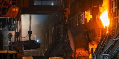 Interior of a steel refinery showing the entrance to a working furnce.