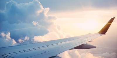 A view of an aeroplane wing in the clouds.
Image via Unsplash/Ross Parmly