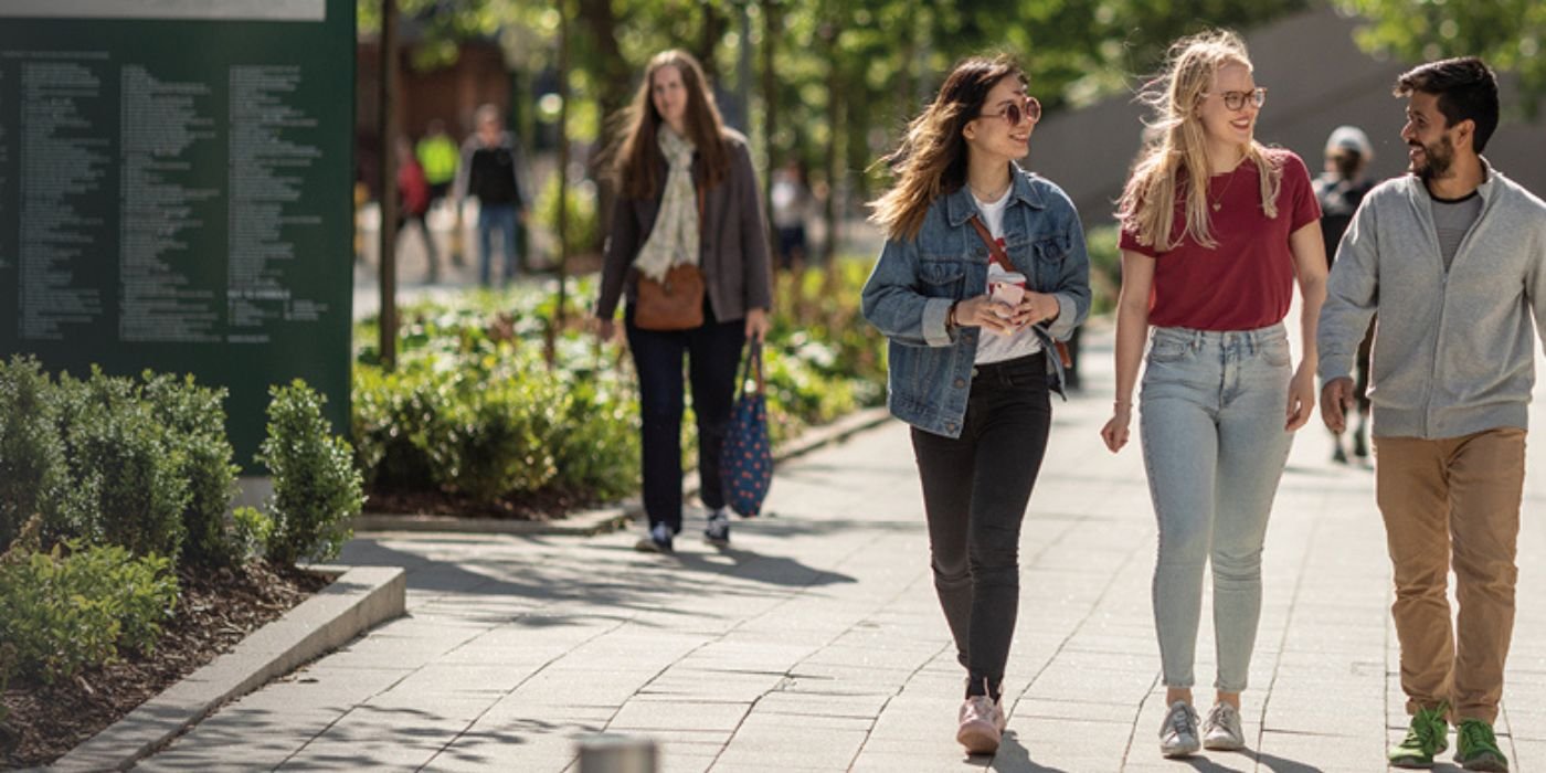 Students walking on campus in the sun