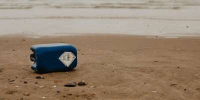 Empty canister of toxic waste on a beach - Credit Beth Junior on Unsplash