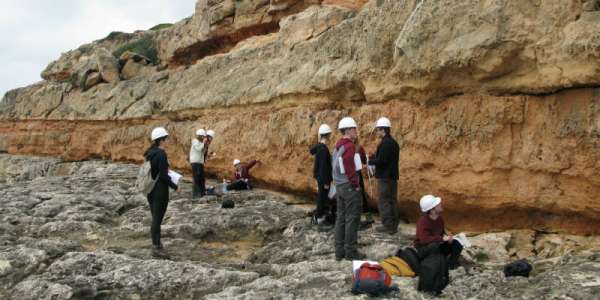 A group of students participate in fieldwork in a rocky scene in Mallorca